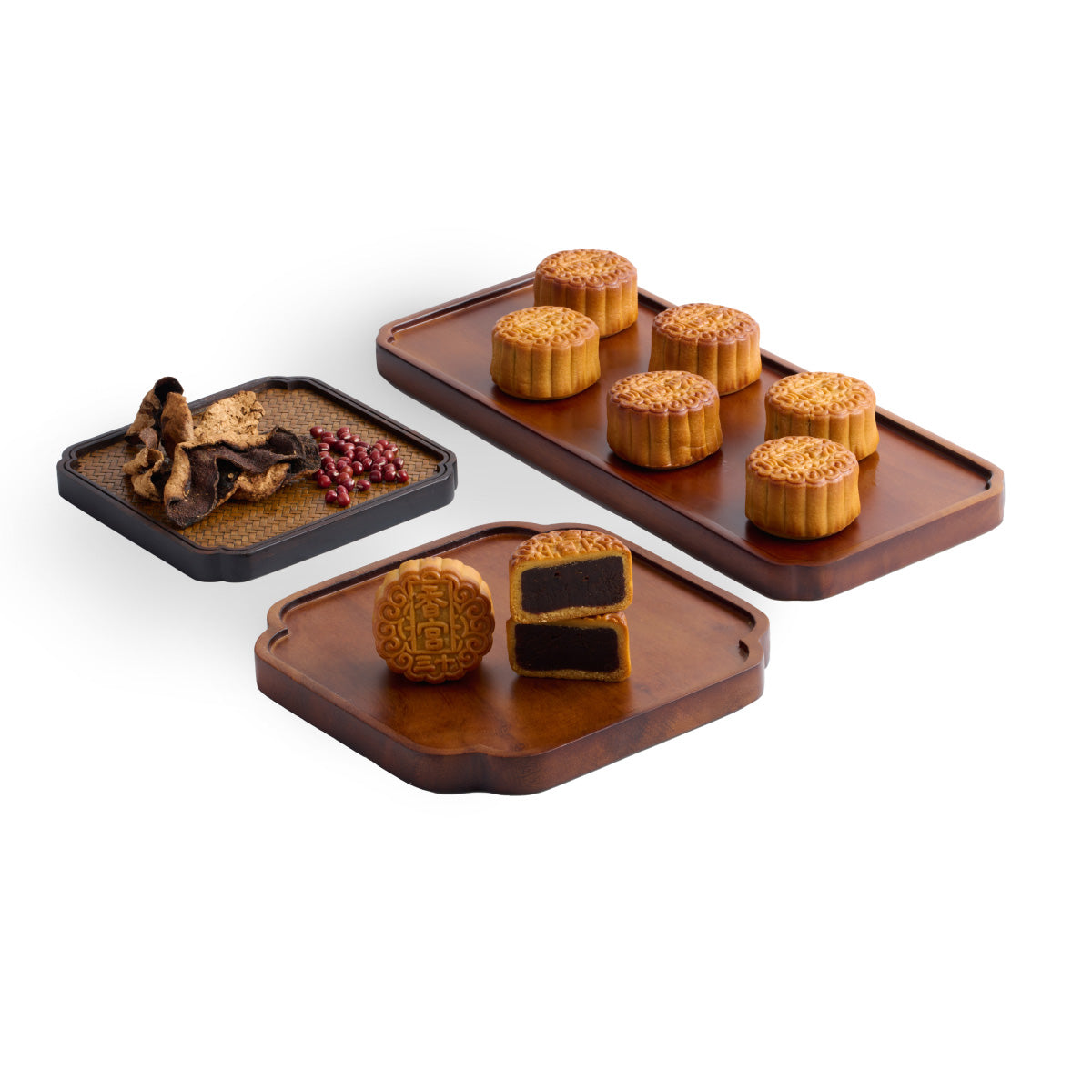 Mooncake assortment with stamped pastries on black and brown serving boards