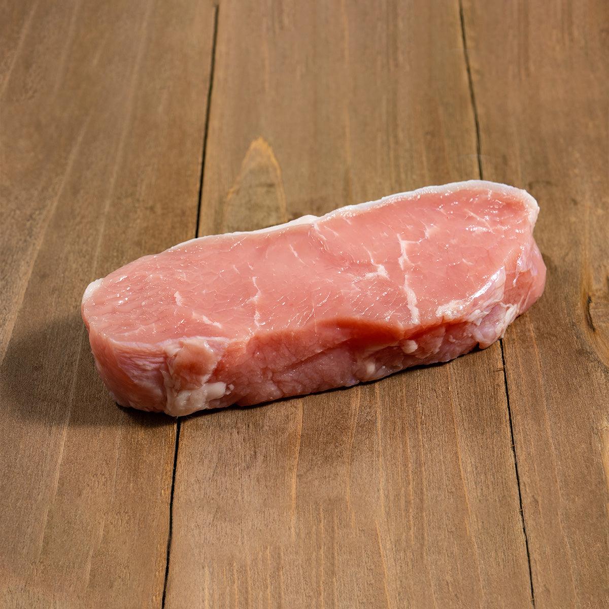 Chilled veal loin steak, pink meat with white fat cap