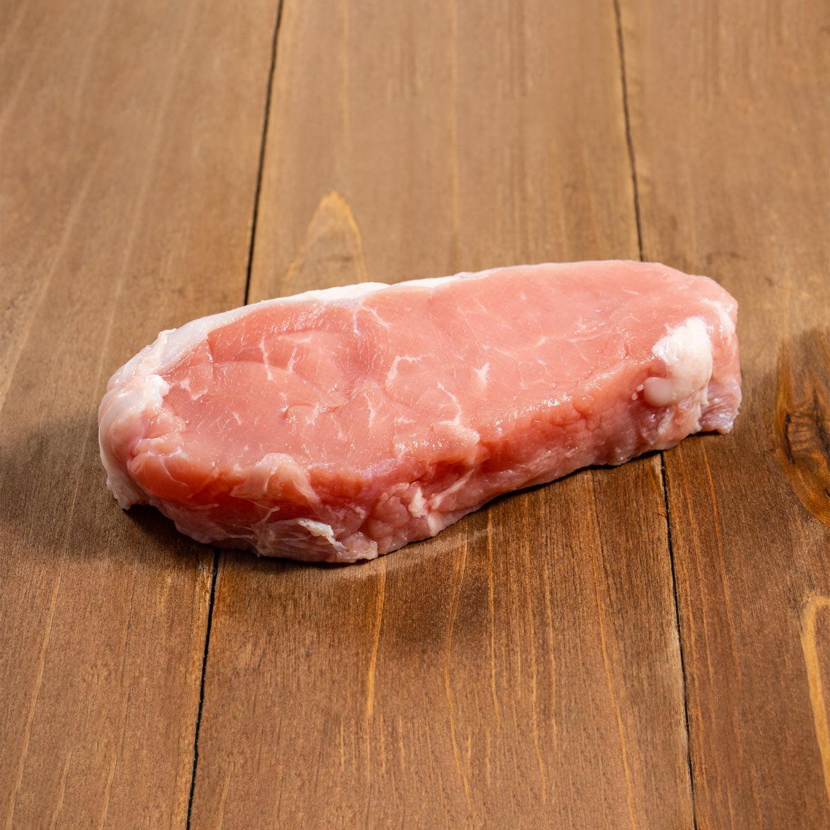 Chilled veal loin steak, rounded cut with marbled pink and white fat