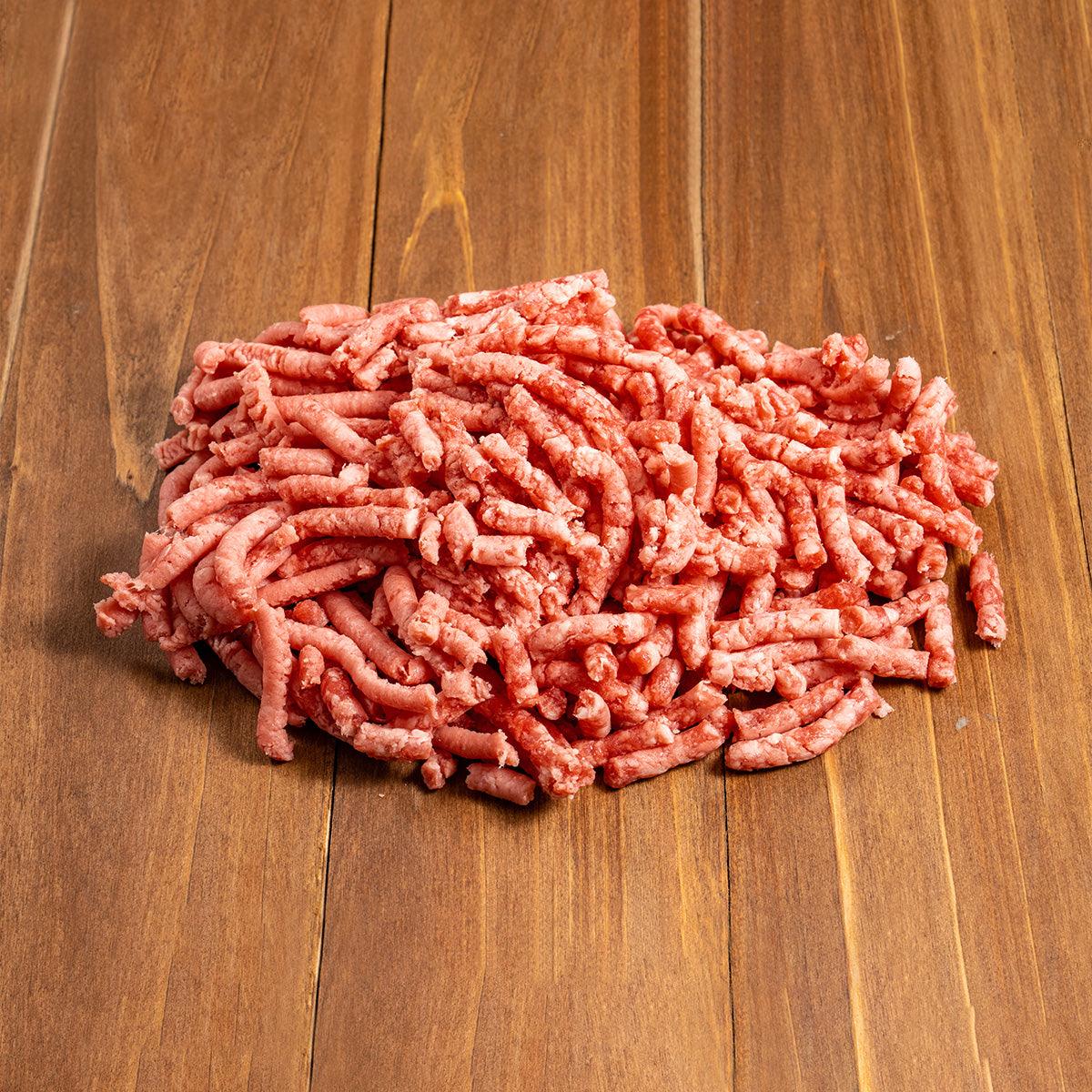 Minced lamb meat, pink-red with white fat flecks.