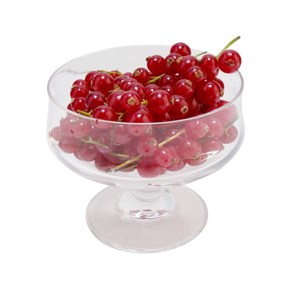 Dutch red currant pack in a glass bowl with glossy red berries and stems
