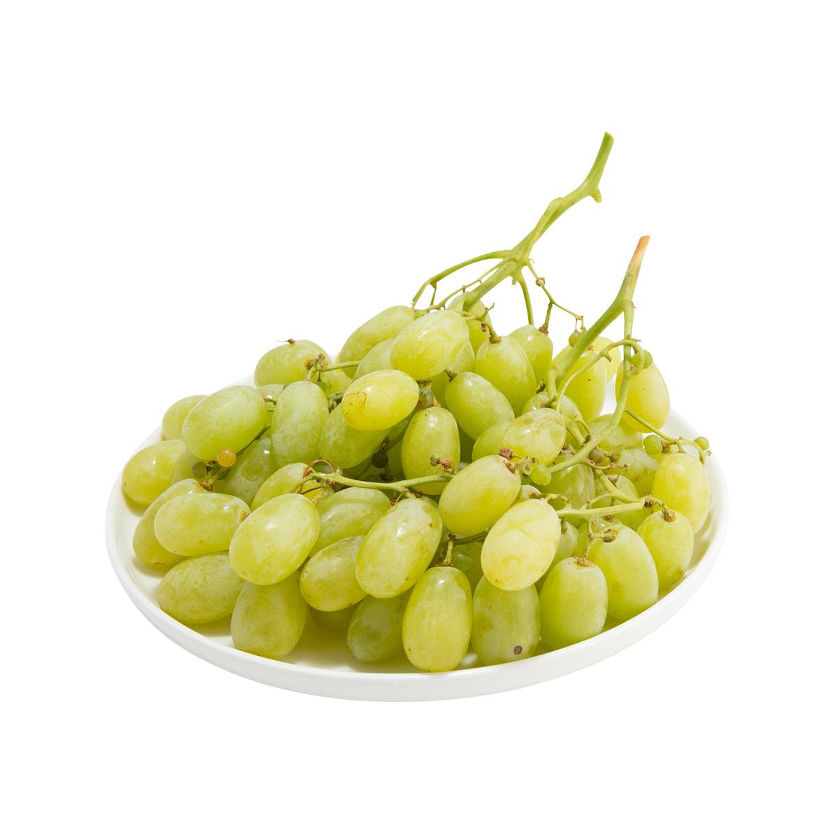 Seedless green grapes in a white bowl, fresh, on stems