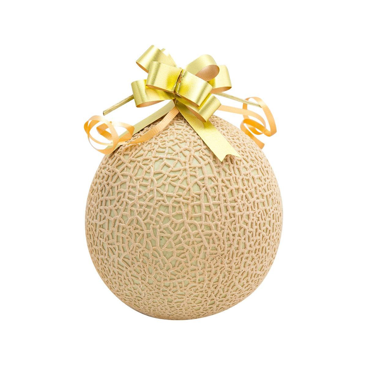 Crown melon with textured rind, tied with gold ribbon bow