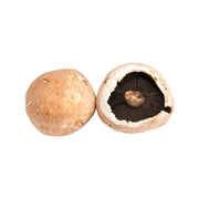 Dutch portobello mushrooms, one whole and one halved, showing dark gills and stem