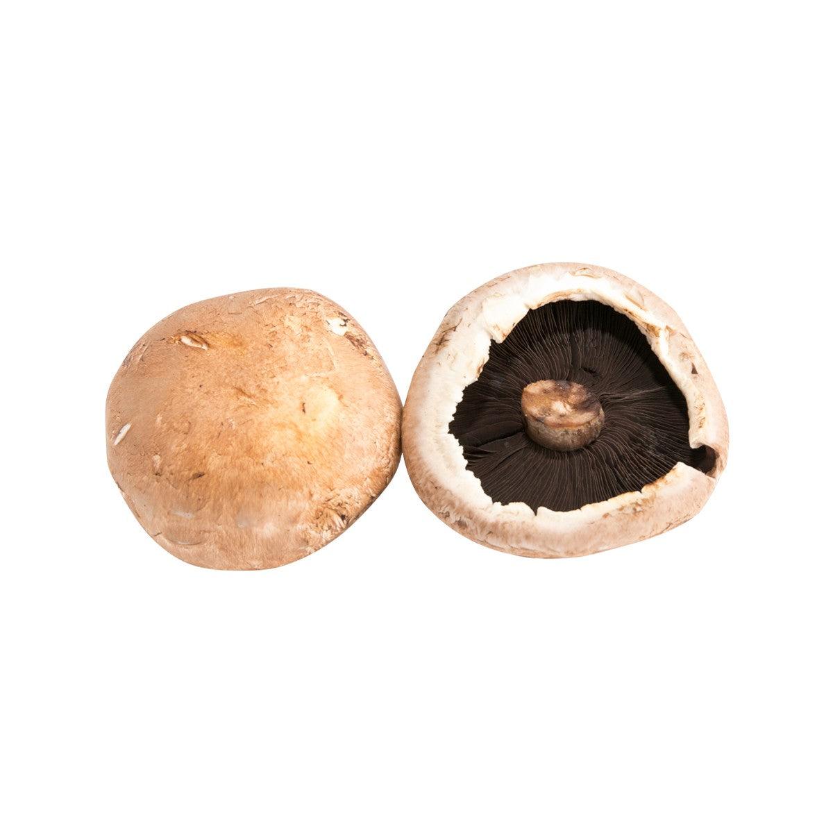Dutch portobello mushrooms, one whole and one halved, showing dark gills and stem