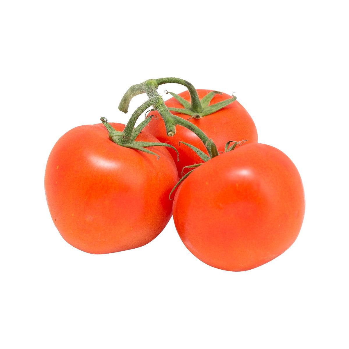 Vine-ripened red tomatoes, three whole tomatoes with green stems and leaves