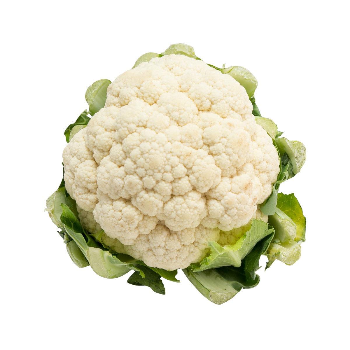 Organic cauliflower head with green leaves, pale cream florets