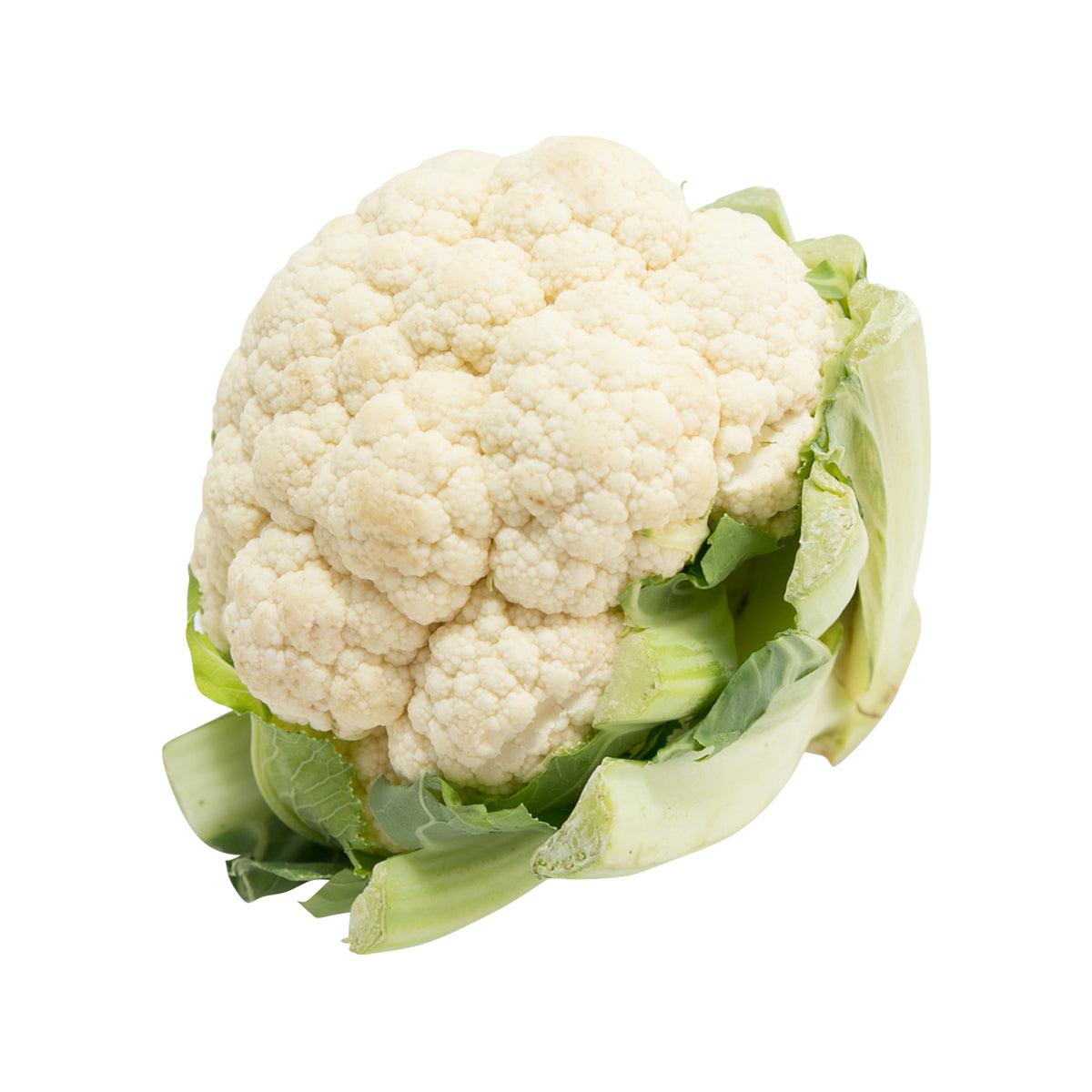 Organic cauliflower head with thick green leaves and pale cream florets