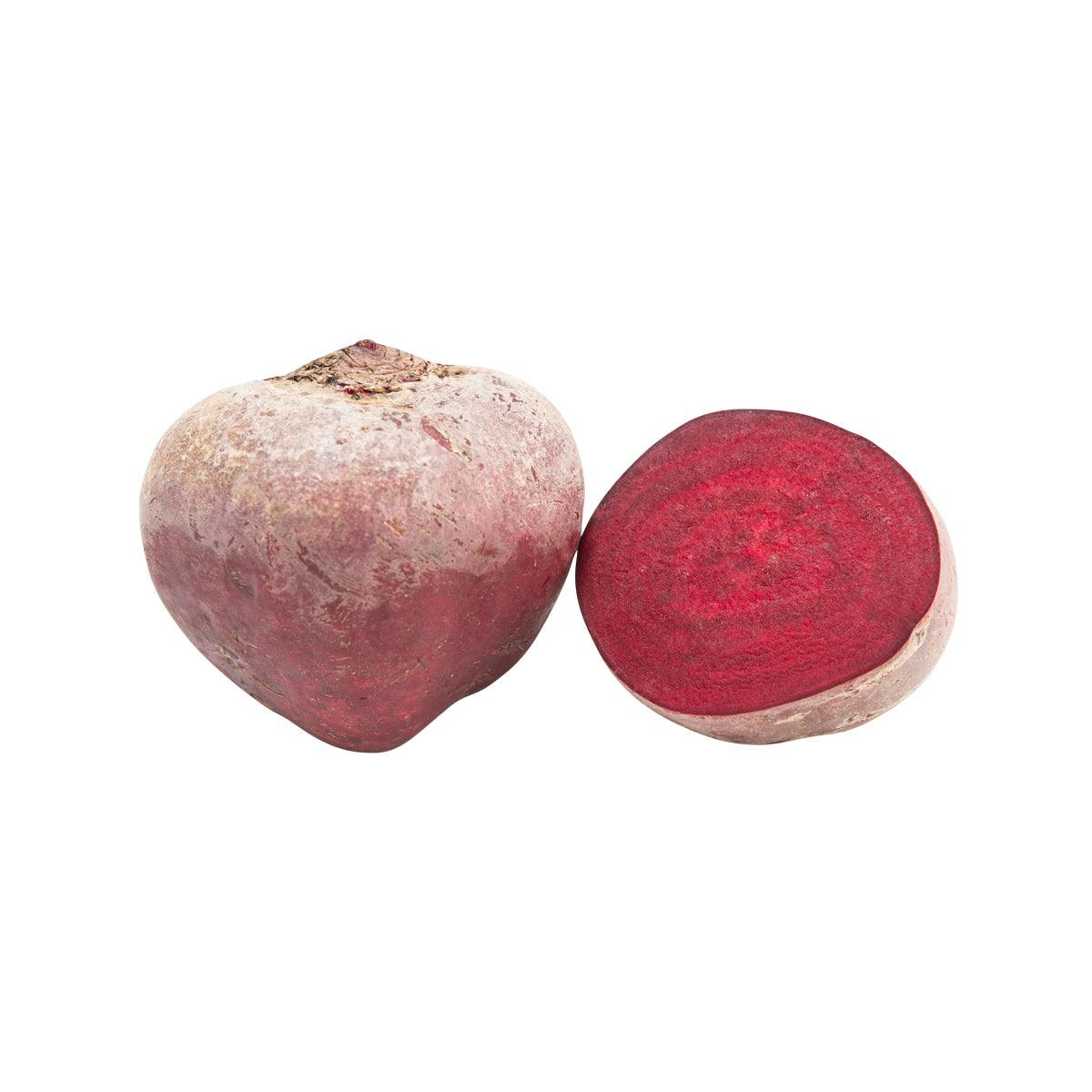 Two fresh beetroot, one showing deep red flesh
