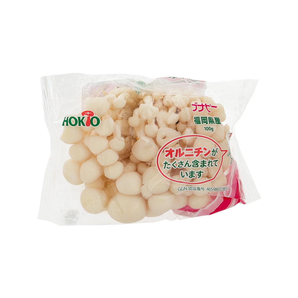 Packaged white bunapi shimeji mushrooms, 100 g bag with front label