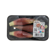 Pack of Japanese myoga ginger, pale green stalks with reddish tips in clear plastic