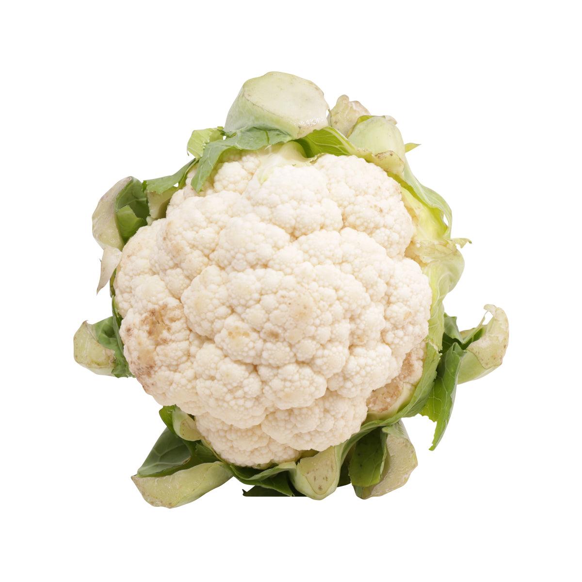 Fresh white cauliflower head with green leaves