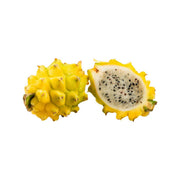 Yellow pitahaya (dragon fruit) halves, one cut showing black seeds and white flesh