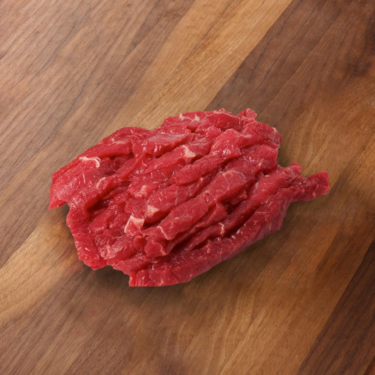 Organic beef stir-fry strips, raw red meat cut for cooking