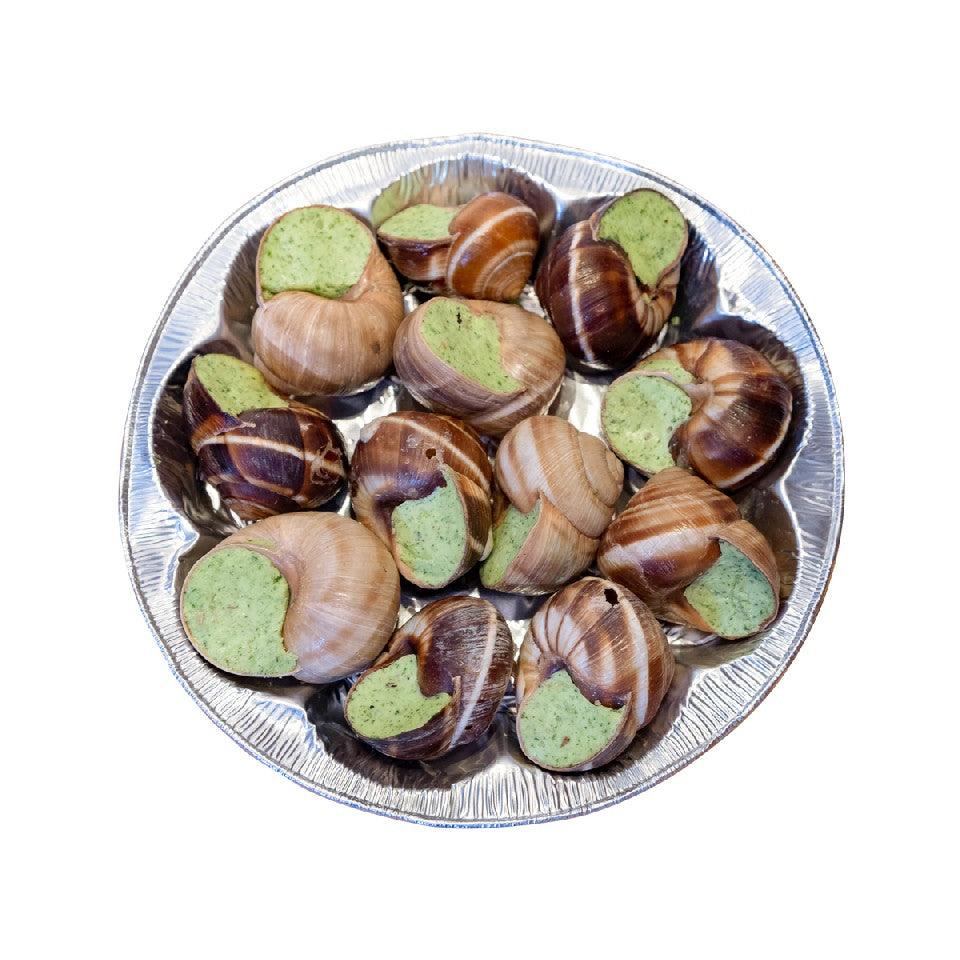 French escargot pieces in foil tray, brown spiral shells with green herb filling