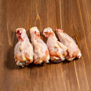 Frozen chicken drumettes, raw meat pieces with visible bones