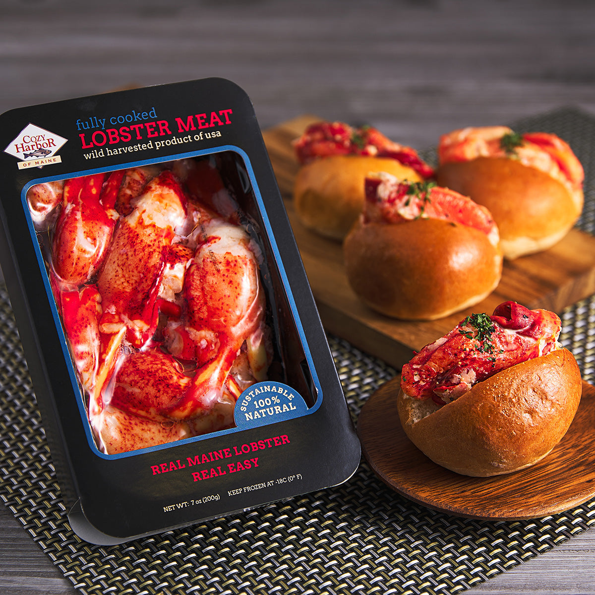 Frozen fully cooked lobster meat package with lobster pieces beside crust rolls