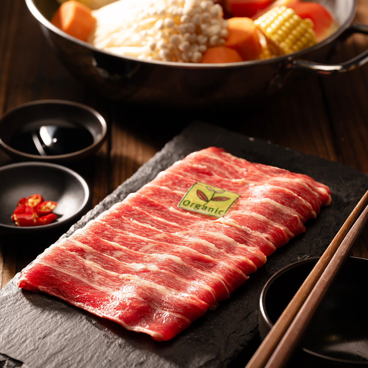Raw boneless beef short rib with green organic label, marbled red-white