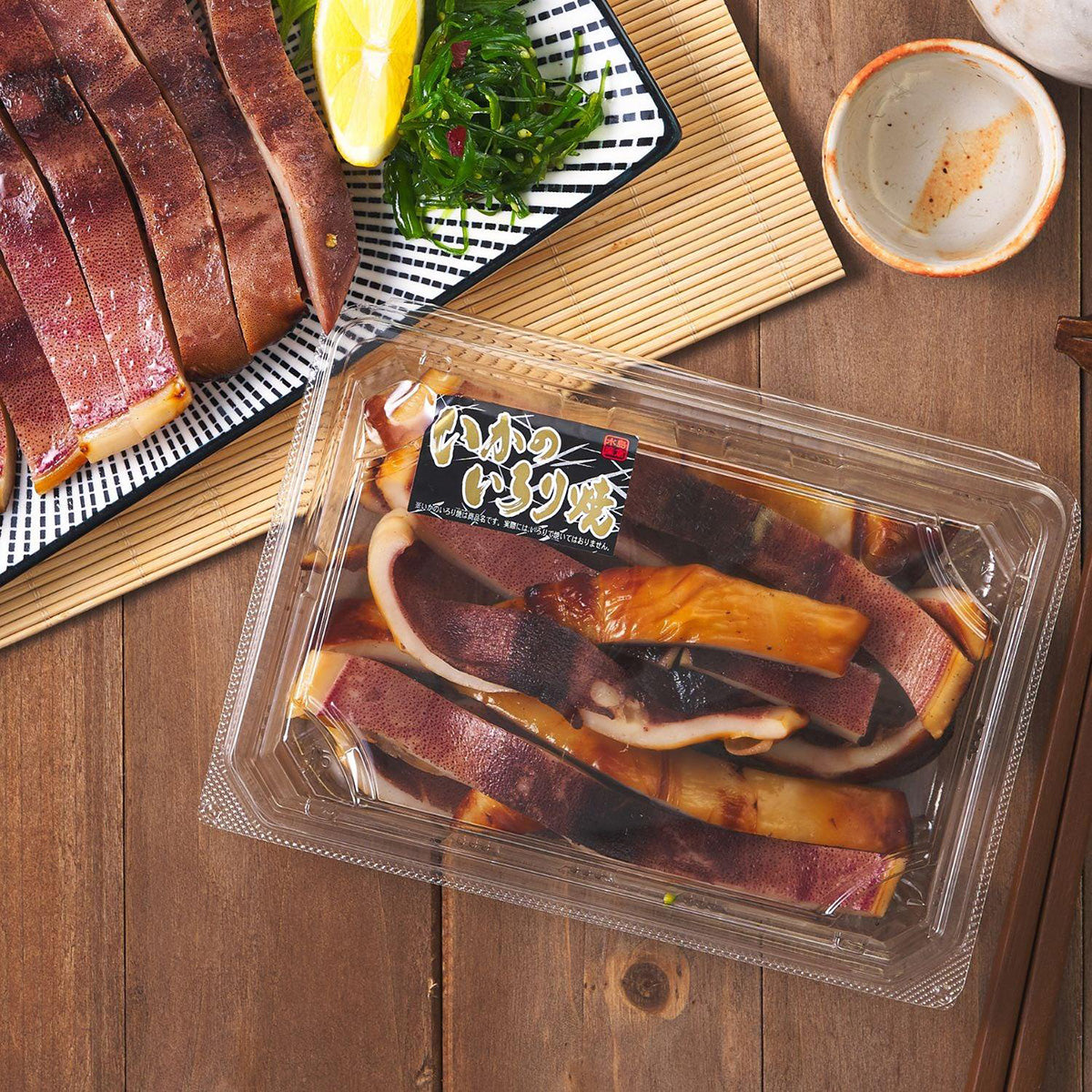 Packaged grilled squid slices in clear plastic tray with Japanese label