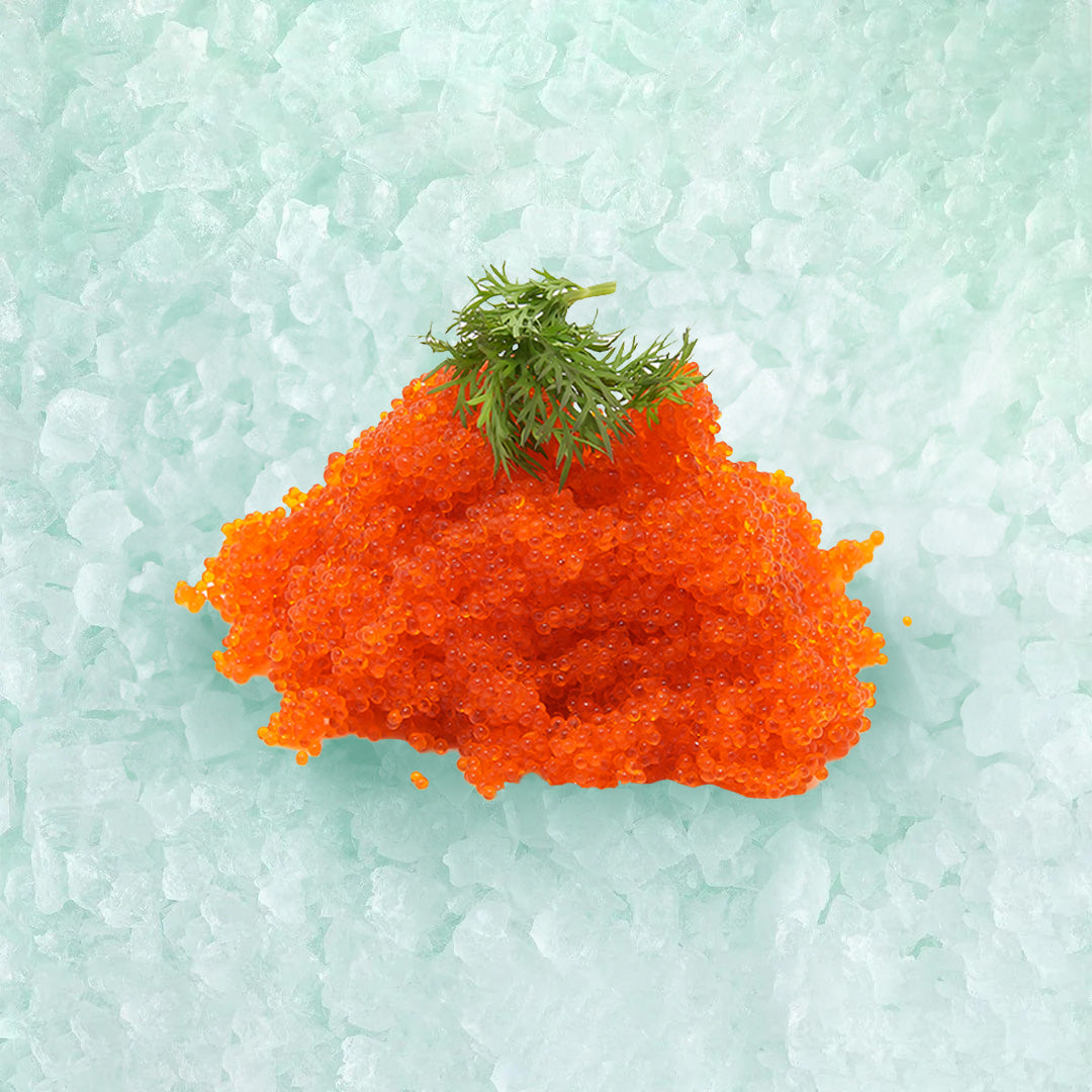 Flying fish roe mound with green garnish, bright orange roe granules