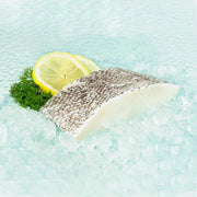 Frozen Australian toothfish fish slice with lemon wedge and herb garnish