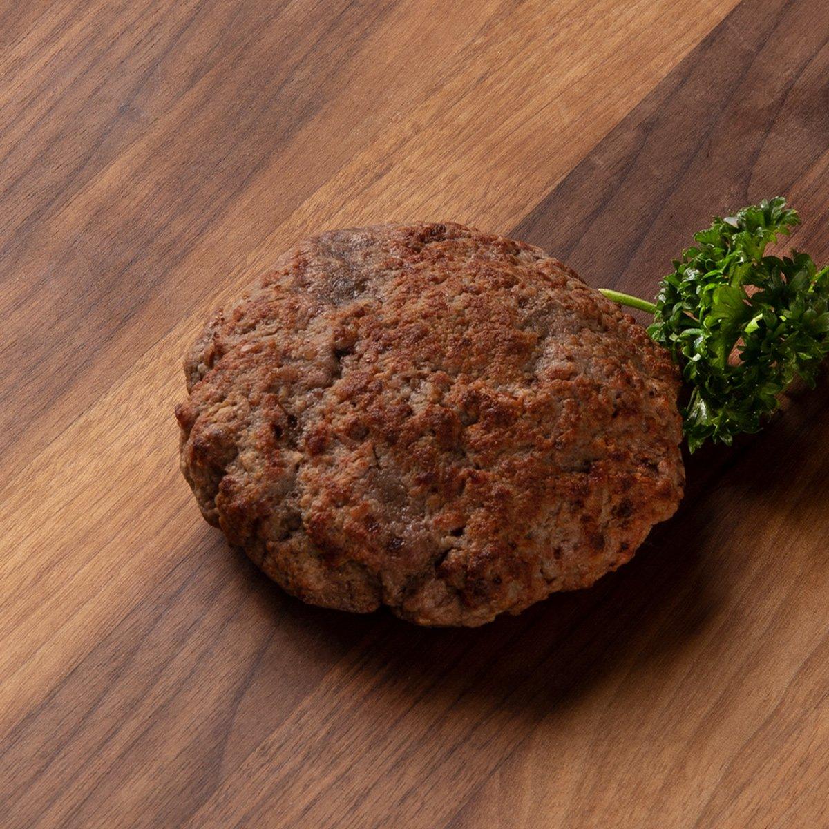 Frozen beef hamburger patty, brown, with parsley sprig
