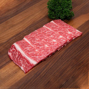 Boneless short rib slices with marbled red and white fat, packaged for yakiniku
