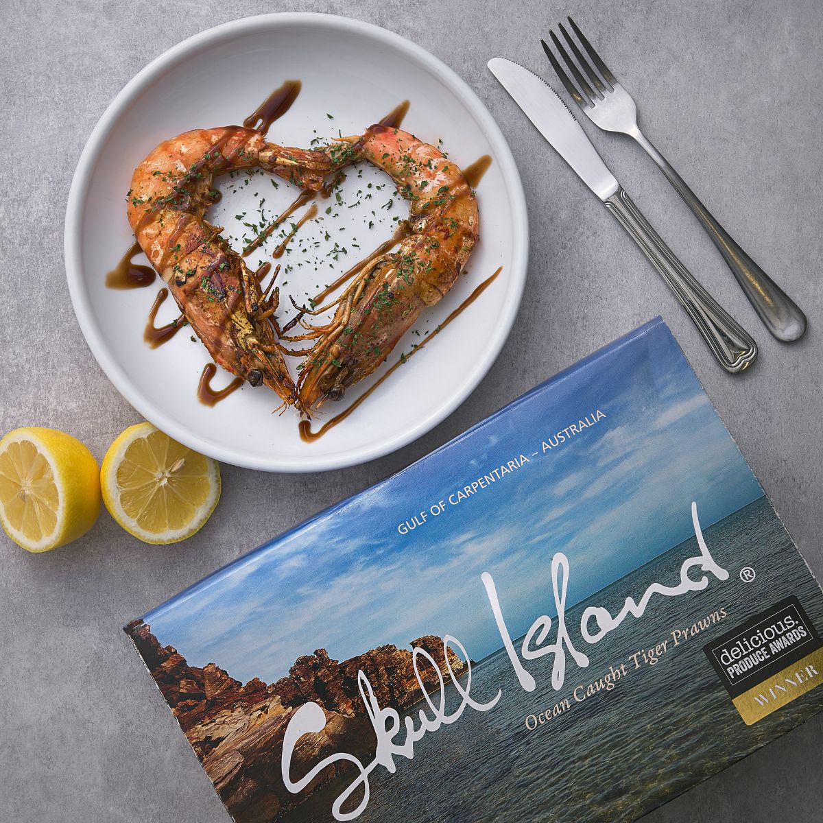 Cooked tiger prawns in a bowl with seasoning and blue product package