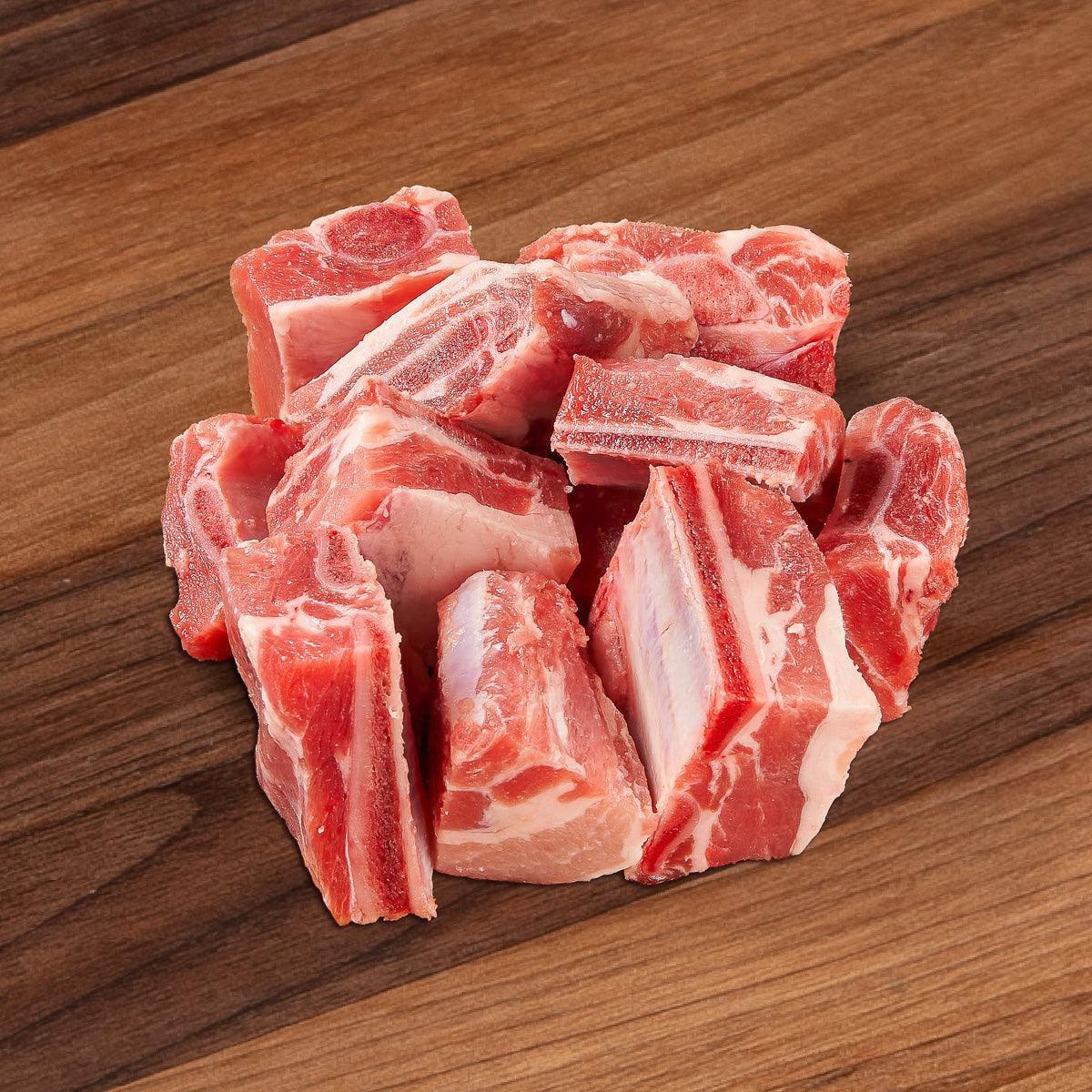Raw pork riblets, assorted pieces with red meat and white fat