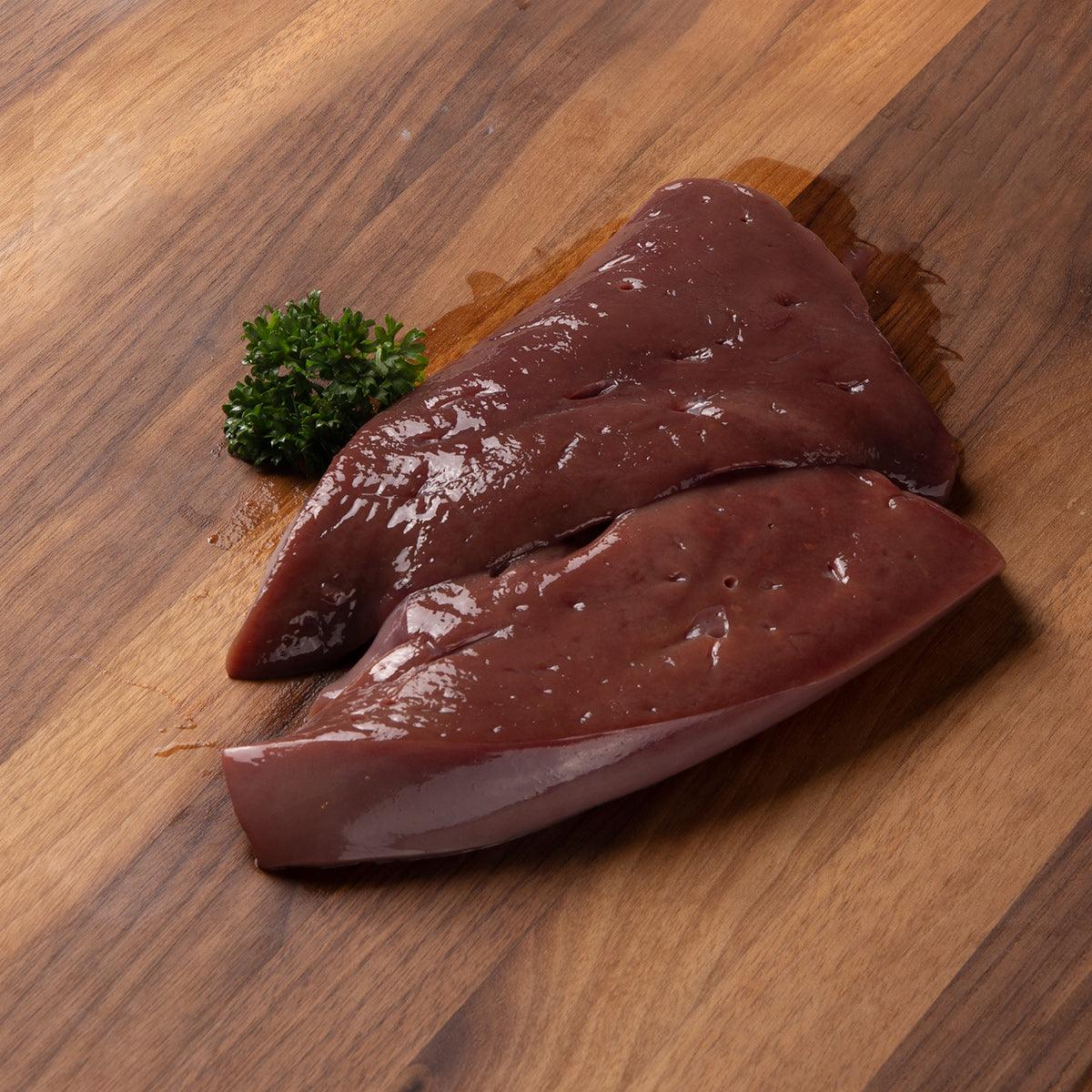 Frozen veal liver, two dark maroon slices