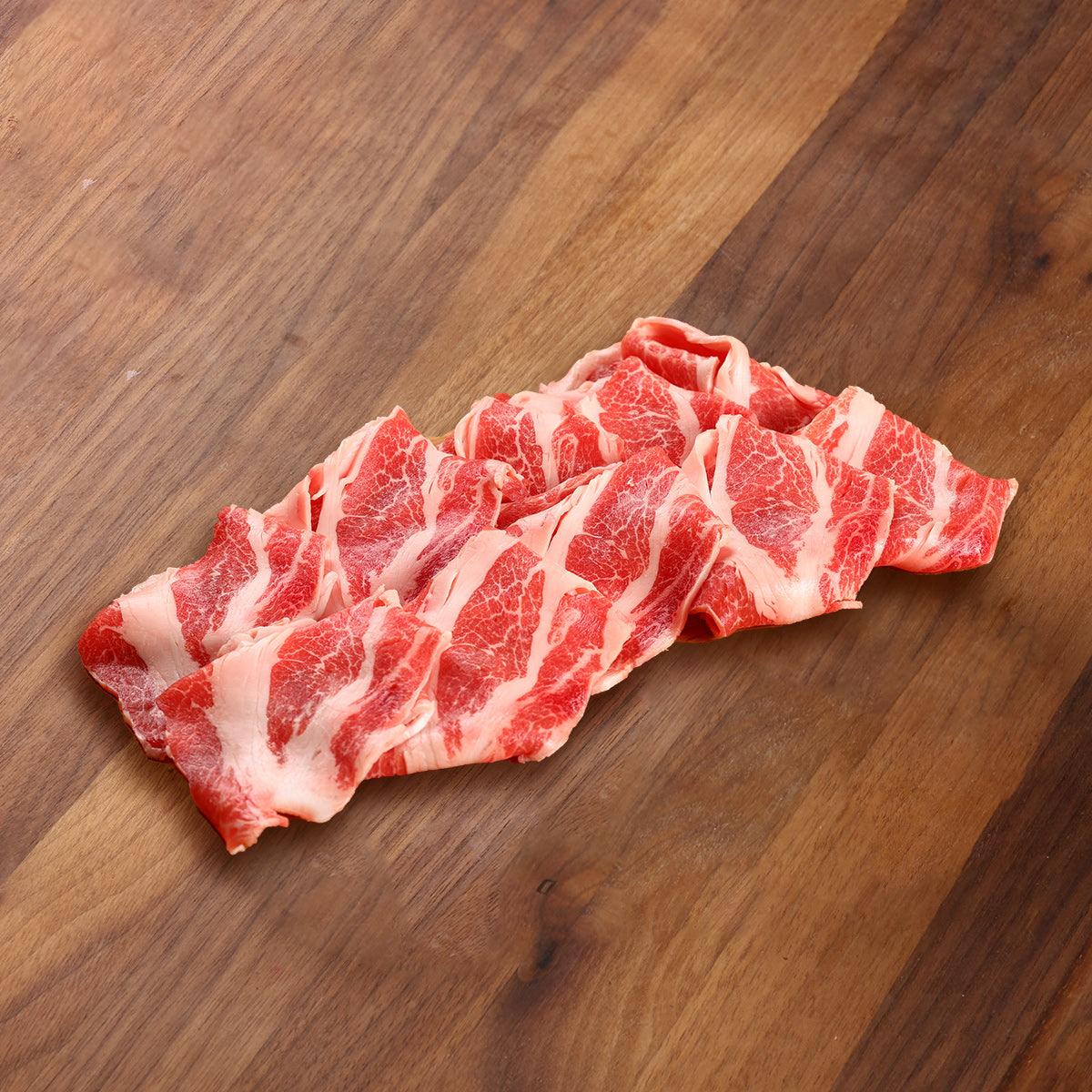 Spanish Iberico pork belly slices with marbled red and white fat, ready for cooking