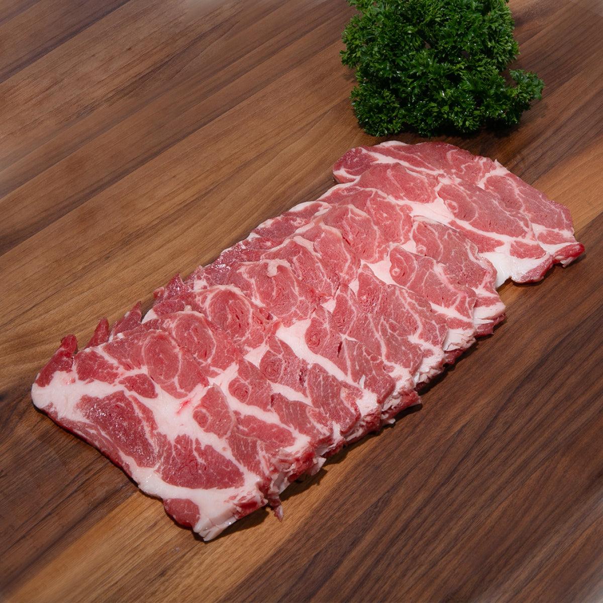 Iberico pork yakiniku slices with visible marbling, raw