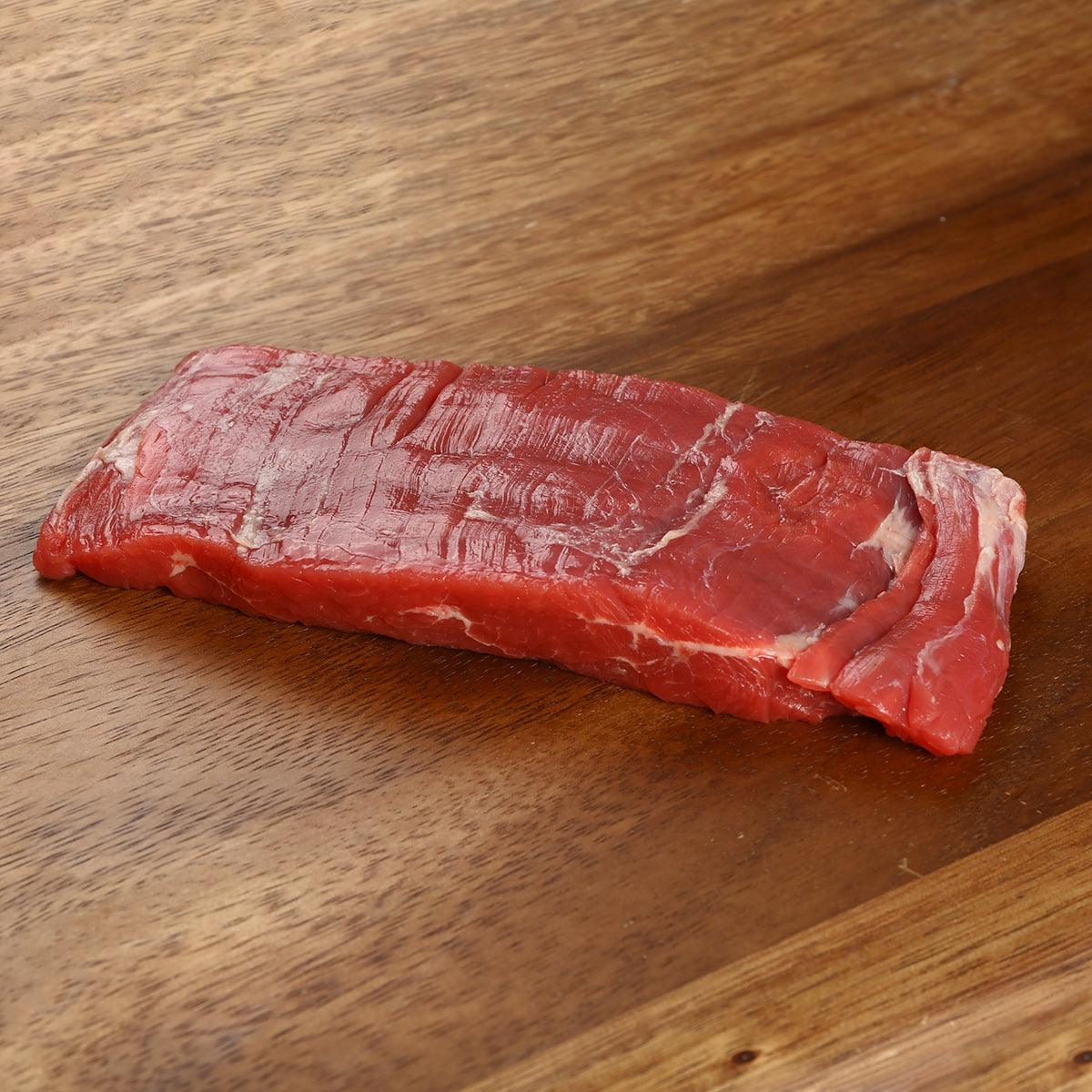 Raw organic beef flank steak, 200 g, red with visible marbling