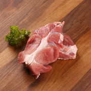 Chilled organic pork shin, raw meat pieces with visible white fat and marbling