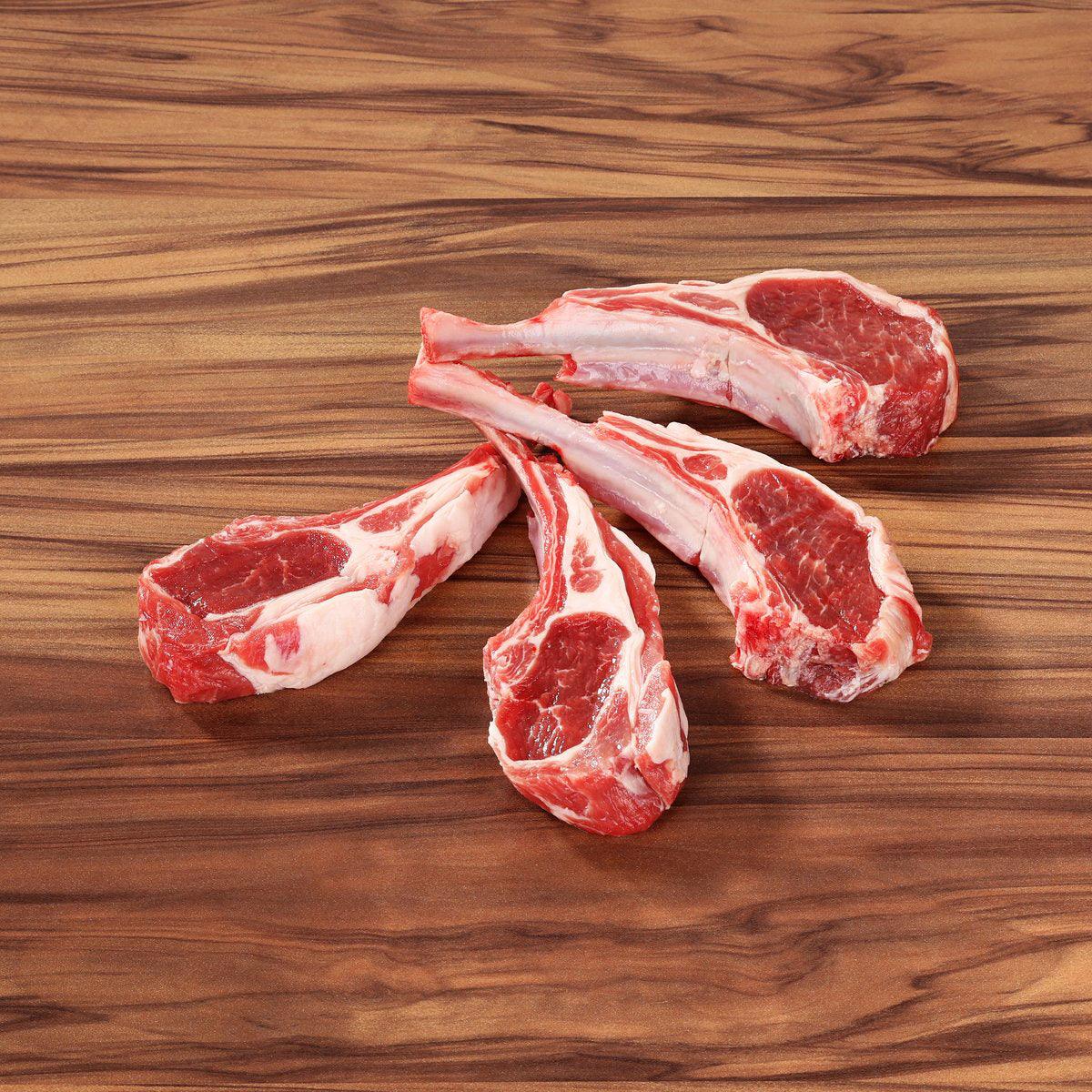 Chilled lamb rack chops with exposed rib bones, raw red meat