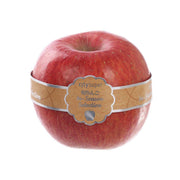 Red speckled apple with branded paper band label, single fruit