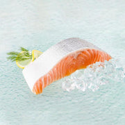 Chilled organic salmon fillet, bright orange with skin, served on ice