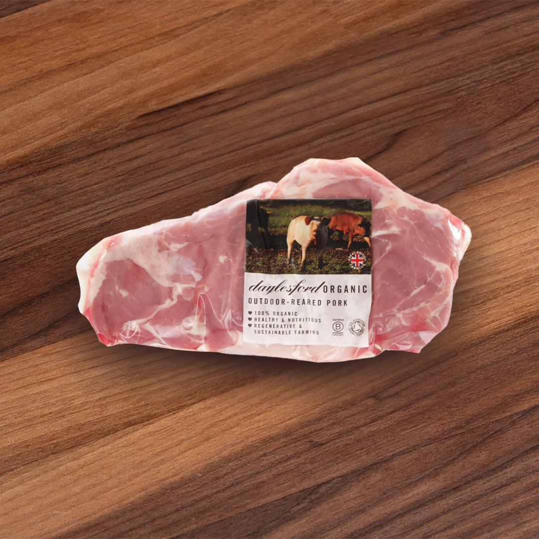 Chilled pork collar, vacuum-sealed with green label and marbled pink meat
