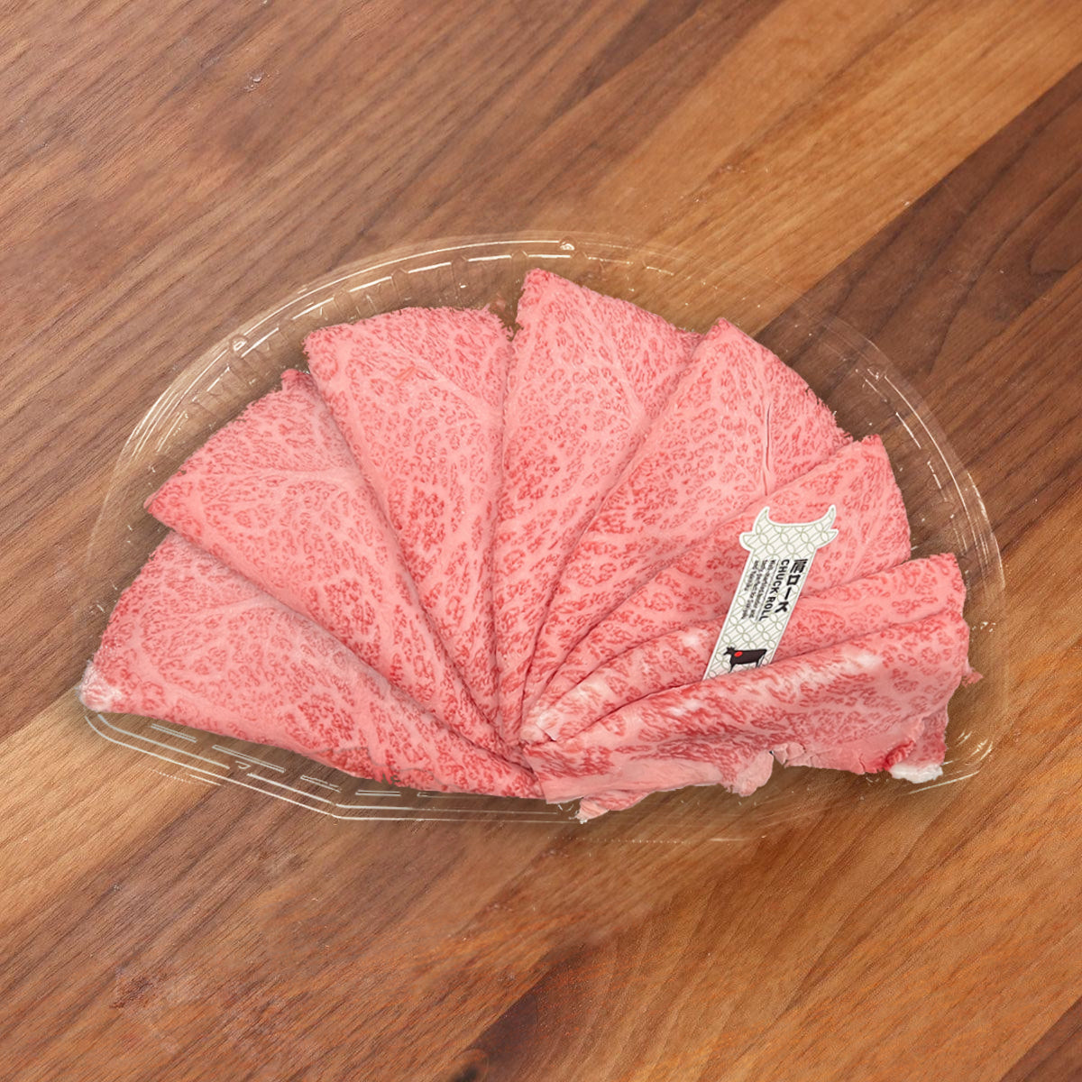A5 wagyu striploin beef in clear tray, pink marbled slices