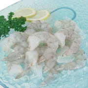 Frozen king prawn meat, pale white shrimp pieces in ice