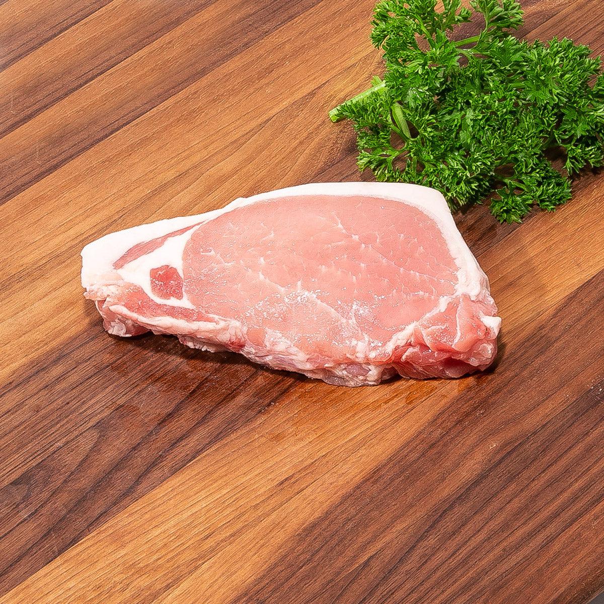 Raw pork loin cut with visible fat cap, pink-red meat
