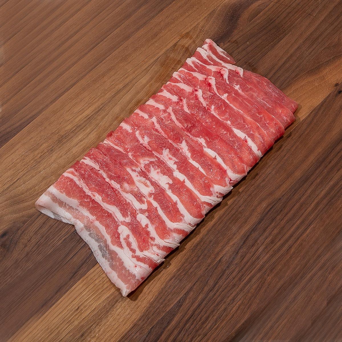 Thick-cut pork belly slab with red-and-white marbled fat layers