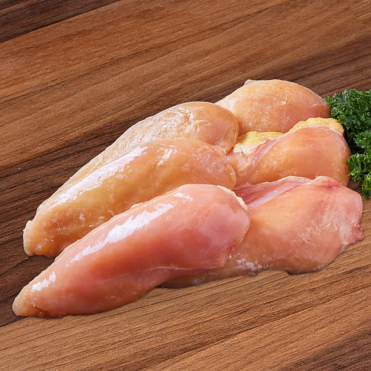 IQF frozen chicken breast cuts, pale pink pieces with parsley garnish