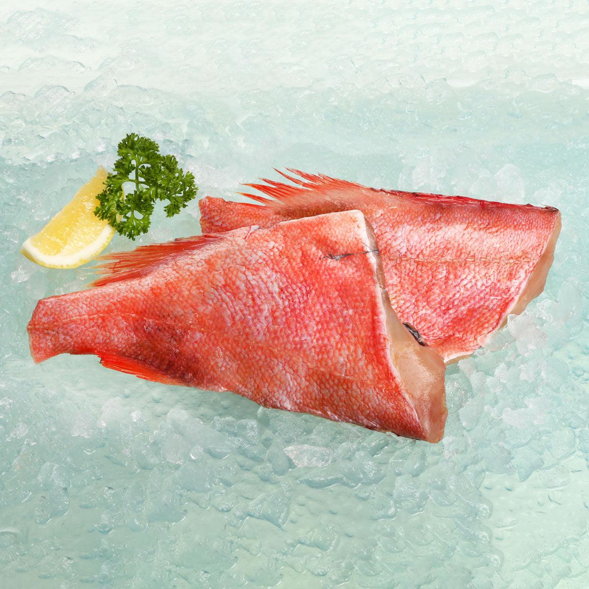 Frozen dried red perch fish fillets, two triangular pieces with skin on