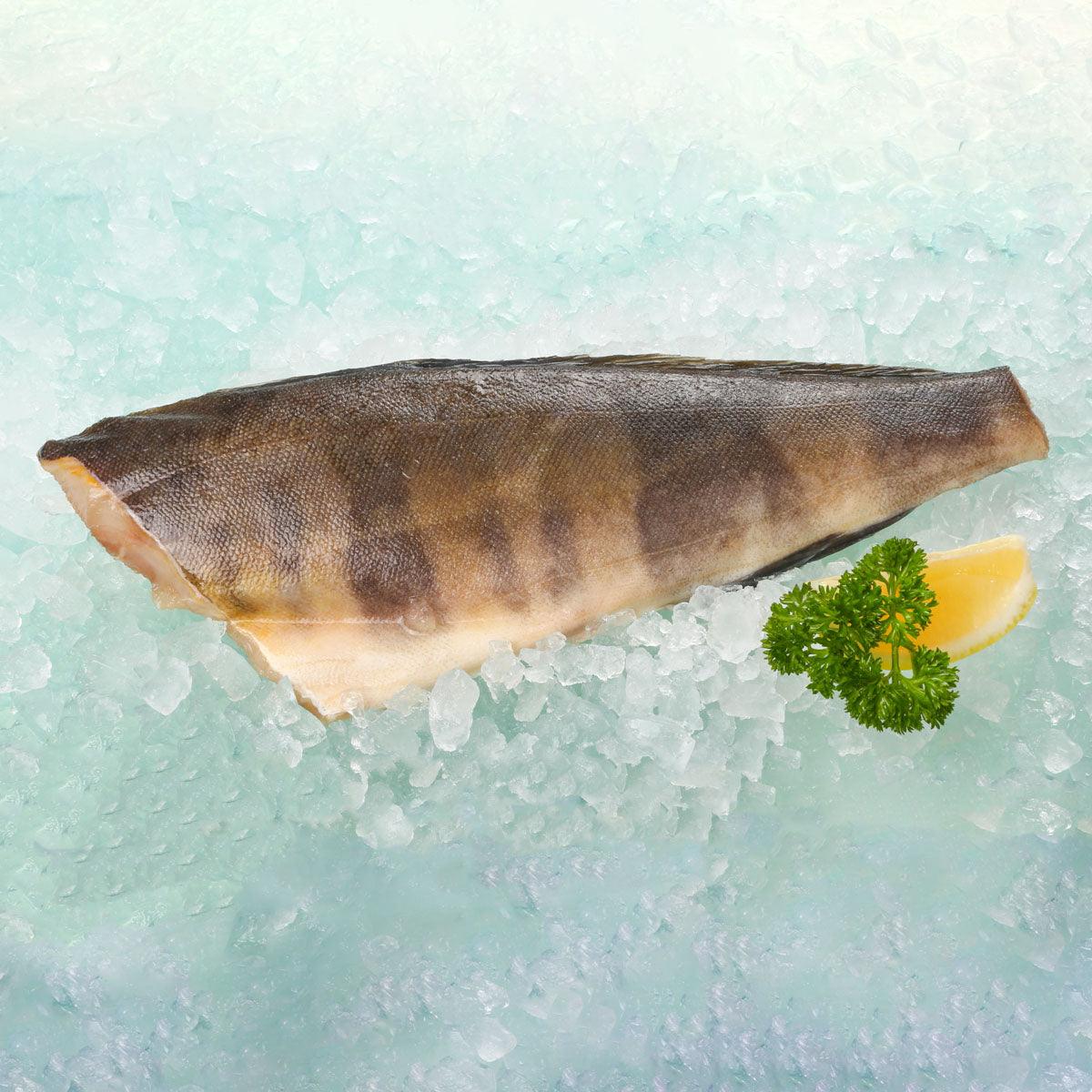 Dried half-cut mackerel fillet on ice, with lemon wedge and parsley