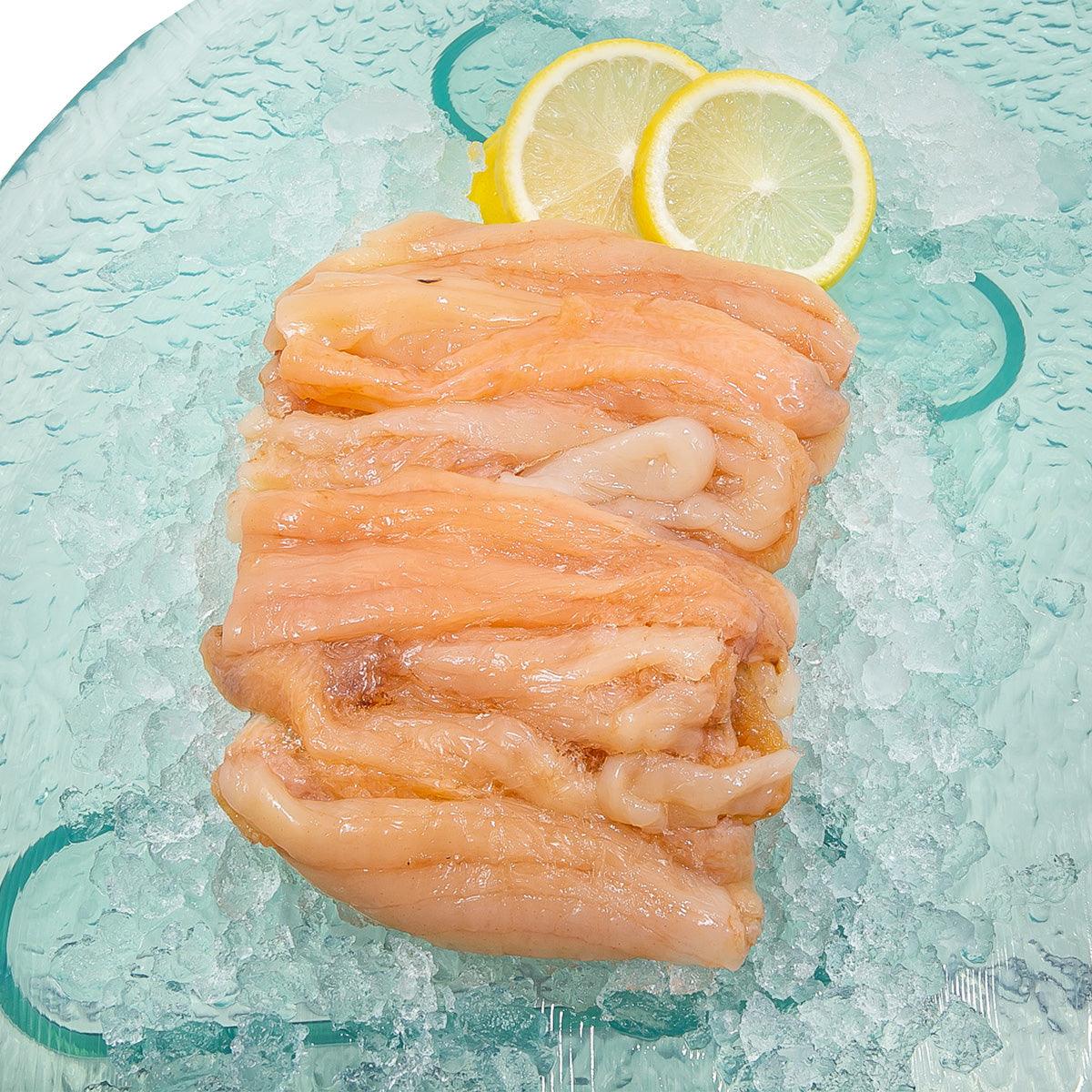 Previously frozen sea cucumber meat, pale orange chunks in a single portion