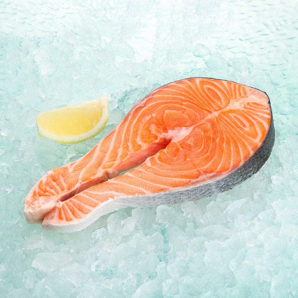 Chilled salmon steak, orange raw fillet with white fat lines