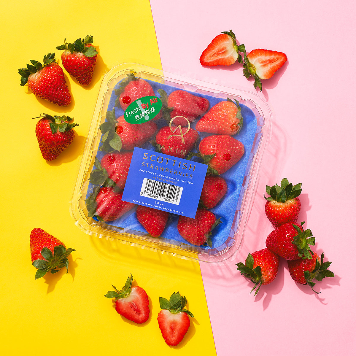 Small strawberry clamshell pack with red strawberries and green leaves around it