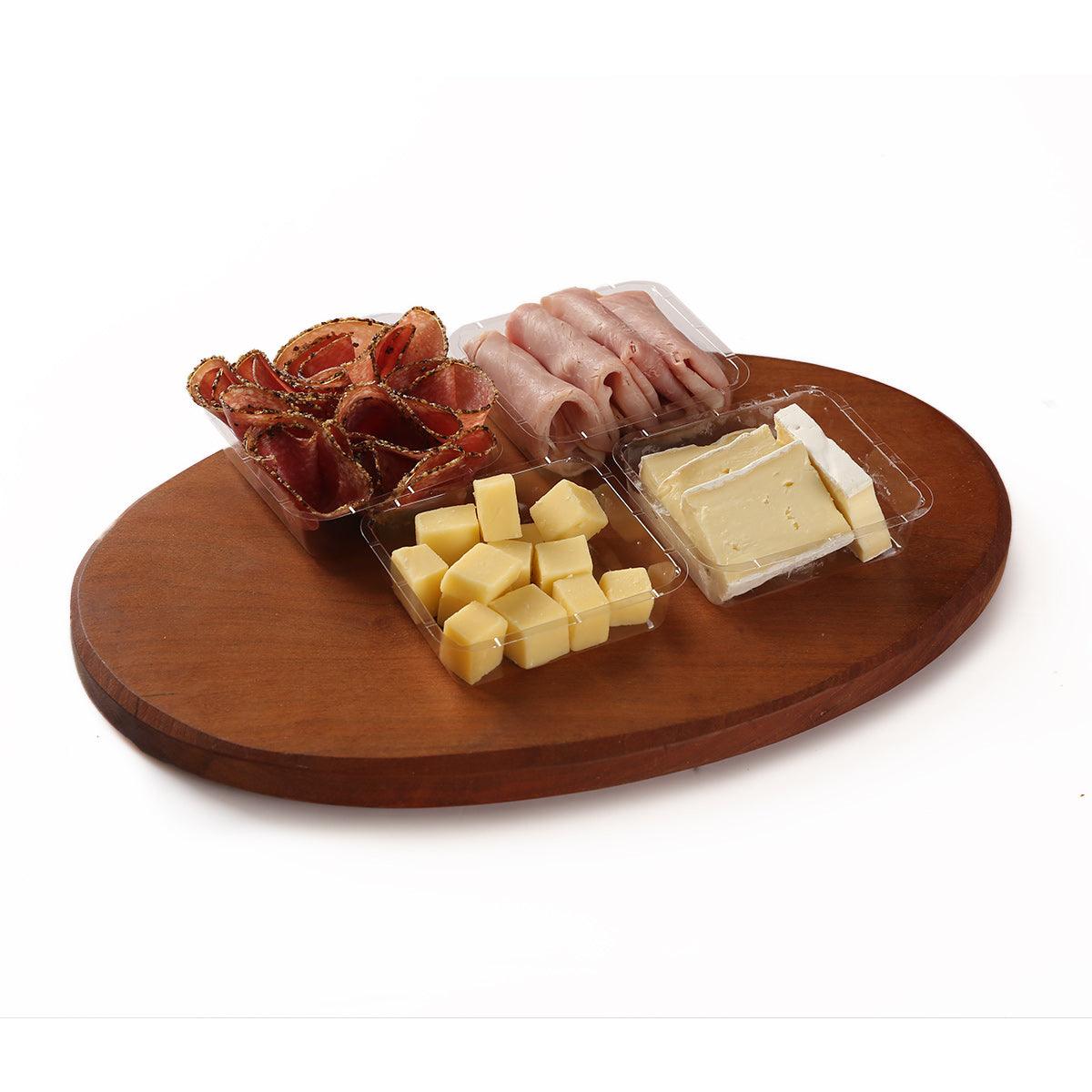 Wooden weekend platter board with cheese cubes and sliced cured meat
