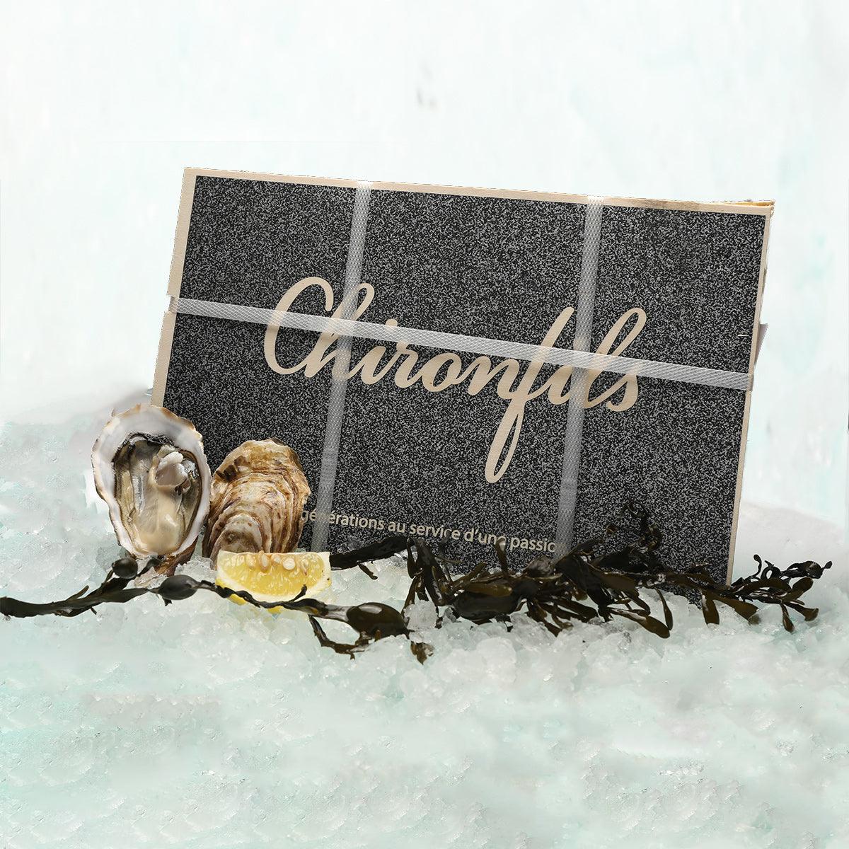 Oyster case with boxed set and open oyster shells on ice